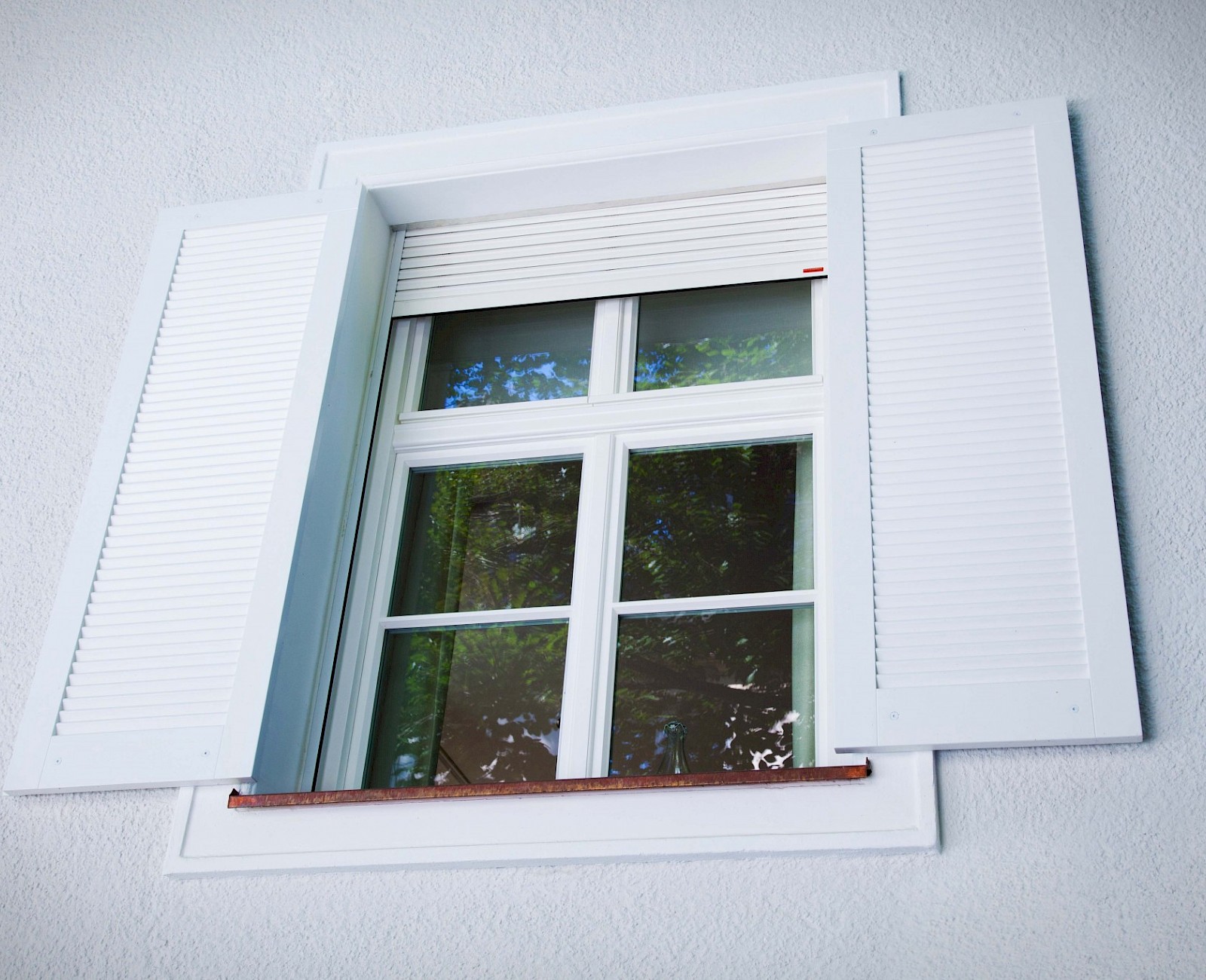 Windows with wooden folding shutters